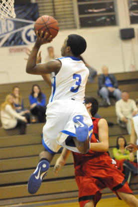 C.J. Rainey flies in for a layup. (Photo by Kevin Nagle)