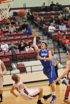 Luke Rayburn throws up a shot after contact with Cabot's Michael Smith. (Photo by Kevin Nagle)