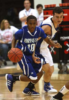 Bryant's Anthony Black clears the ball, working up the floor under pressure. (PHoto by Rick Nation)