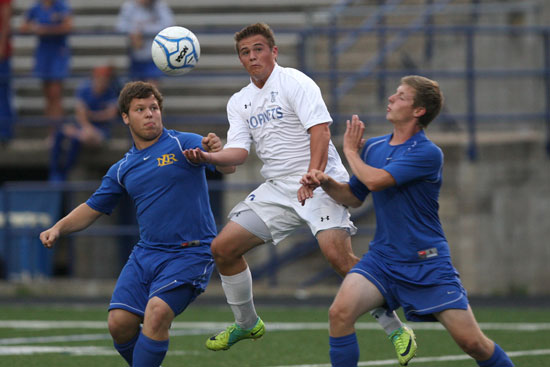 Bryant's Forrest Fowler contends with a pair of North Little Rock players. (Photo by Rick Nation)