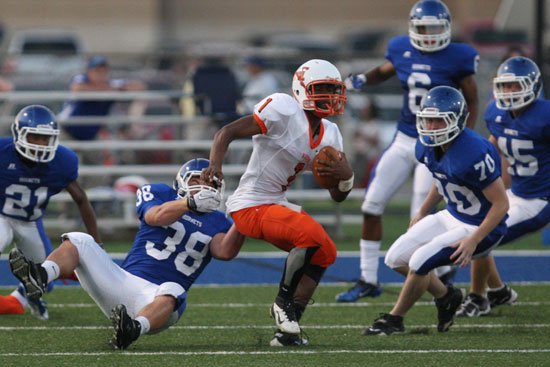 Hall quarterback Malik Shelton (1) is tracked down by Bryant's Colton Burton (38) as Jacob Stringer (70), Mark Nelson (21), Tanner Rich (45) and Brenden Young (6) pursue. (Photo by Rick Nation)