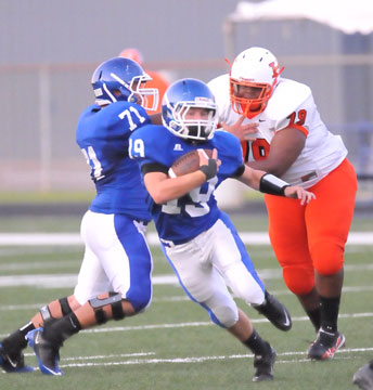 Jacob Irby (19) breaks upfield off a block by Bryant center Blaine Jackson (71). (Photo by Kevin Nagle)