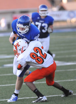 Tight end Nate Rutherford (88) runs into Little Rock Hall defensive back Keion Thorton (82) as guard Blake Hobby (73) trails the play. (Photo by Kevin Nagle)