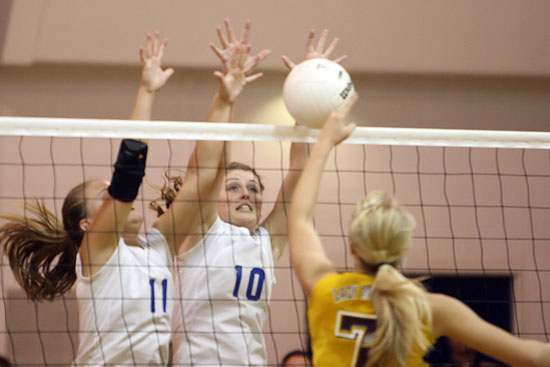 Hannah Rice (11) and Alyssa Anderson (10) smother a Lake Hamilton player's hit. (Photo by Rick Nation)