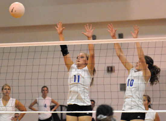 McKenzie Rice (12) and Alyssa Anderson (10) got up to block a Texarkana hit. (Photo by Kevin Nagle)