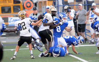 Players from both teams scrap for a loose ball. Though Central's Tom Coulter (82) appears to have recovered teammate Terrian Griham's fumble, Bryant's Stoney Stevens, on the ground, wound up with the ball. (Photo by Kevin Nagle)