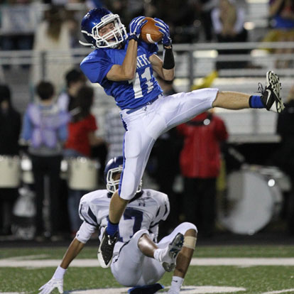 Bryant's Jake East leaps to haul in an interception. (Photo by Rick Nation)