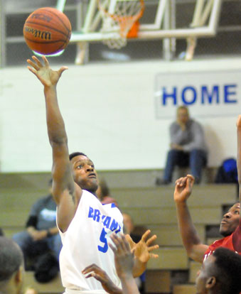 K.J. Hill goes high over a group of Texarkana players for a shot. (Photo by Kevin Nagle)