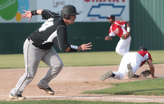 Bryant's Cody Gogus breaks for home as Trevor Ezell's single gets past the diving attempt of Pine Bluff third baseman Chris Connelly. (Photo courtesy of Mike Adam)