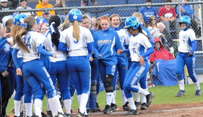 Brianna Forsyth is welcomed to the plate by her teammates after slugging a two-run home. (PHoto by Kevin Nagle)