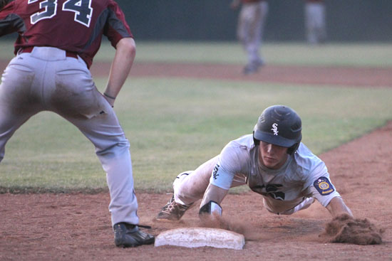 Brandan Warner dives back into first on a pickoff attempt. (Photo by Rick Nation)