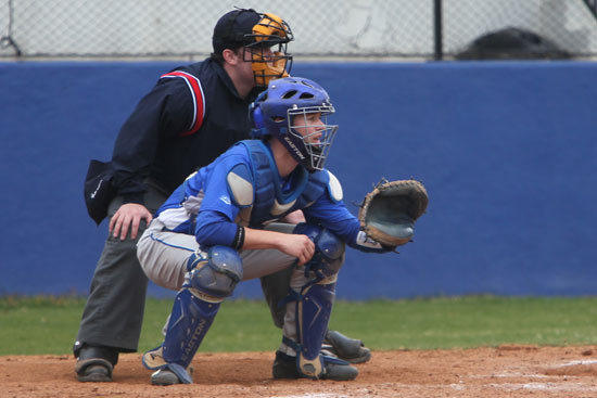 Bryant catcher Trey Breeding sets up to receive a pitch as the umpire looks over his shoulder. (Photo by Rick Nation)