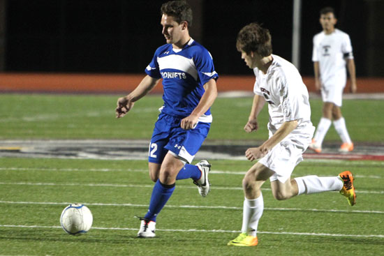 Bryce Denker pushes the ball upfield ahead of a Benton defender. (Photo by Rick Nation)