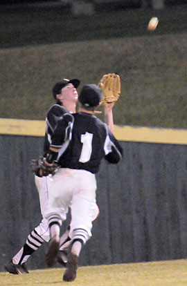 Dalton Holt draws a bead on a flyball to right as teammate Korey Thompson (1) hustles out to help if needed. (Photo by Kevin Nagle)