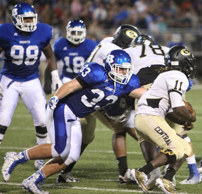 Hayden Knowles (33) tackles running back Richard Hayes (11). Cameron Murray (98) and Marvin Moody (18) pursue. (Photo by Rick Nation)