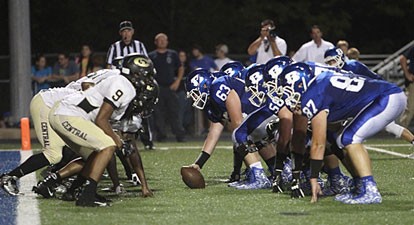 The Bryant offensive line digs in against Central's defensive front moments before a touchdown. (Photo by Rick Nation)