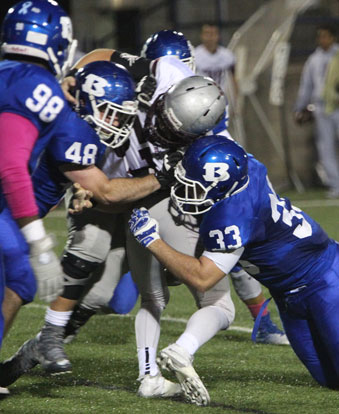 Peyton Robertson (48) and Hayden Knowles (33) combine on a tackle. (Photo by Rick Nation)