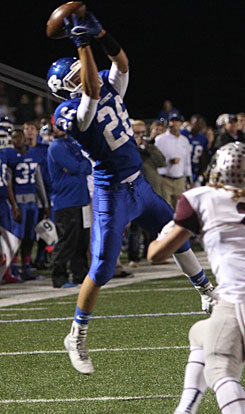 Landon Smith reaches high for one of his four receptions in Friday's game. (Photo by Rick Nation)