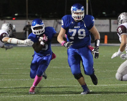 DeAmonte Terry follows teammate Cole Fritschen (79) through an opening on a running play. (Photo by Rick Nation)