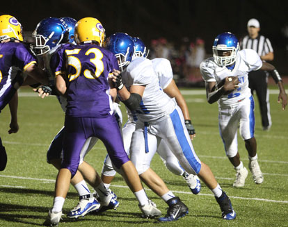 Bryant's offensive line, left, clears space for quarterback Randy Thomas (6) during Wednesday night's game at Catholic. (Photo by Rick Nation)