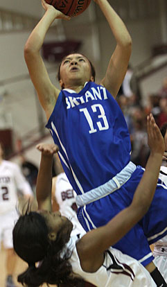 Raija Todd (13) shoots over a Benton defender that was unable to draw a charge. (Photo by Rick Nation)