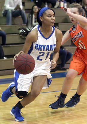 Destiny Martin (21) drives past Sydney Cinnamon of Rogers Heritage. (Photo by Rick Nation)