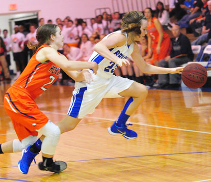 Bryant's Kendal Rogers controls the ball against pressure from a Rogers Heritage defender. (Photo by Kevin Nagle)