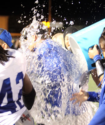 Bryant head coach Paul Calley gets doused after Friday night's win at Conway. (photo by Rick Nation)