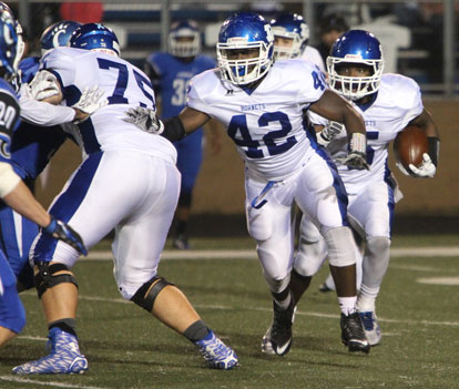 DeAmonte Terry (5) runs behind Demaja Price (42) and Brycen Waddle (75). (Photo by Rick Nation)