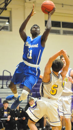 Kevin Hunt scores over Catholic's Austin Alsbrook (5) on his way to a 33-point night. (Photo by Kevin Nagle)