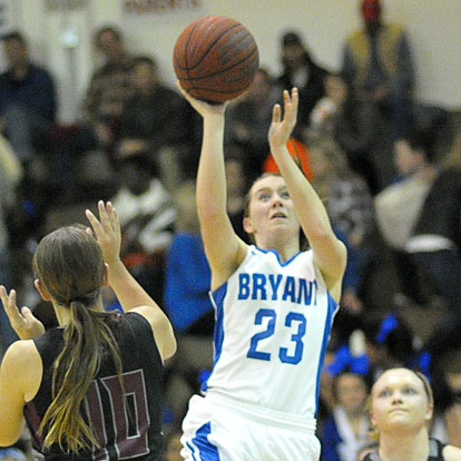 Kendall Rogers (23) splits a pair of Benton defenders on her way to a shot. (Photo by Kevin Nagle)