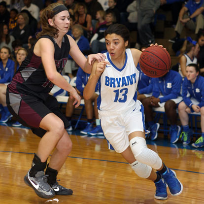 Raina Todd (13) drives the left side on her way to 2 of her game high 19 points. (Photo by Rick Nation)