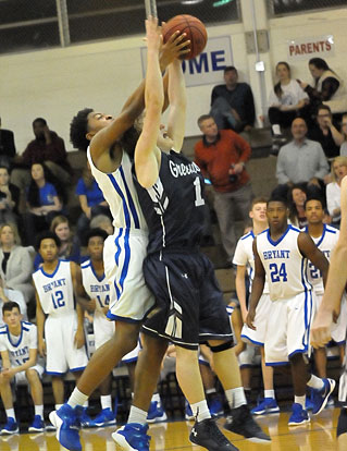 Braylon Steen (25) battles Greenwood's Alec Armstrong for a rebound. (Photo by Kevin Nagle)