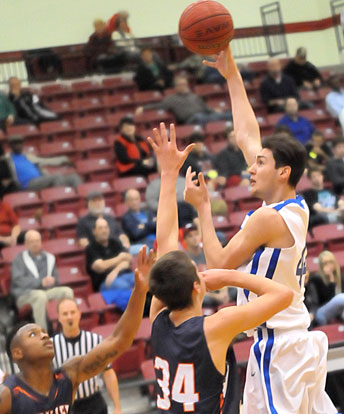 Kyle Sahr fires a hook shot over Heritage post Seth Stanley. (Photo by Kevin Nagle)