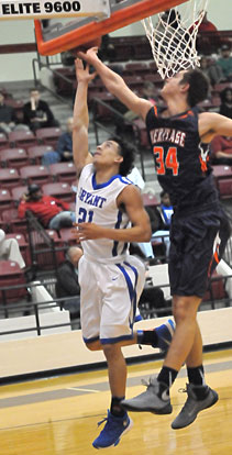 Jordan Walker (21) has his layup blocked by Heritage's Seth Stanley. (Photo by Kevin Nagle)