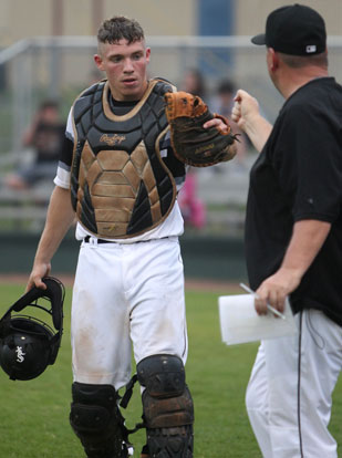 Catcher Jordan Gentry is greeted by Black Sox manager Darren Hurt after Conway was retired. (Photo by Rick Nation)