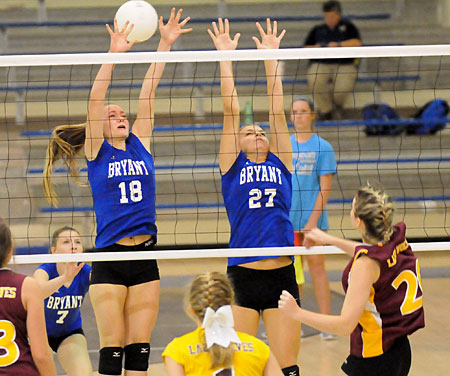 Casey Welch (18) and Grace Camferdam try to get a block. (Photo by Kevin Nagle)