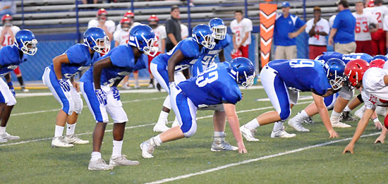 Ready to spring, the Bryant freshman defense lines up to combat Cabot Red's tight dead-T offense. (Photo by Kevin Nagle)