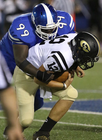 KaJuan Robinson (99) rides down Central quarterback Josh Cole. (Photo by Rick Nation)